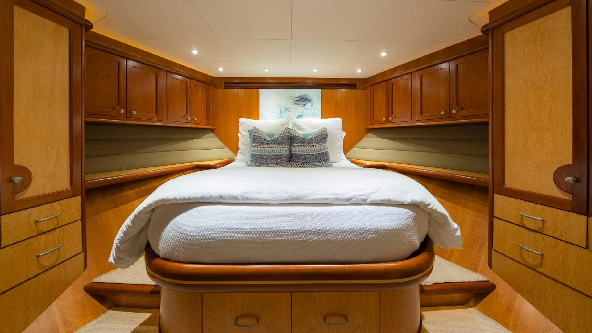 a room with a bed and cabinets aboard MAGICAL DAYS Yacht for Sale