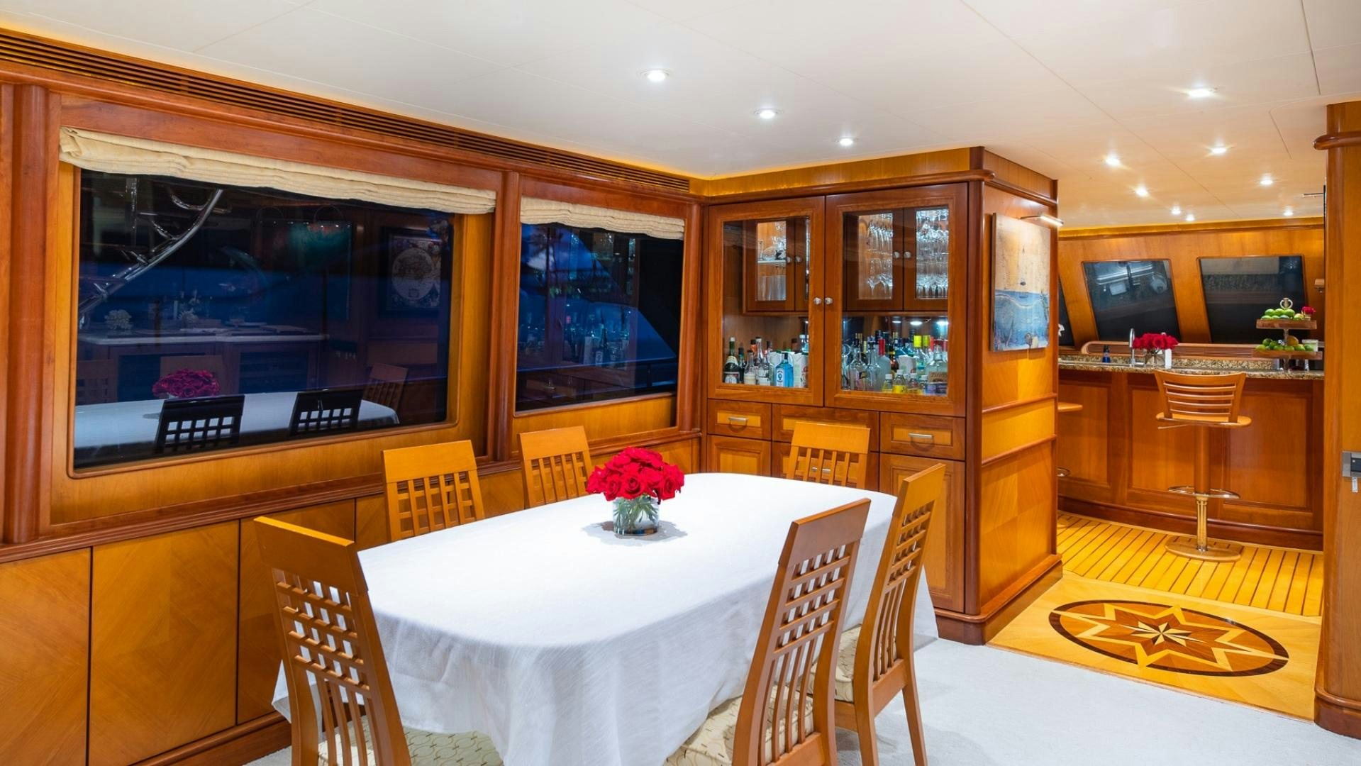 a dining room with a table and chairs aboard MAGICAL DAYS Yacht for Sale
