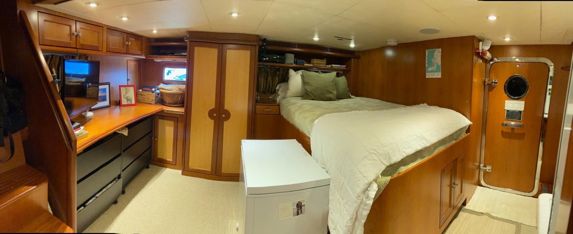 a room with a bed and desk aboard MAGICAL DAYS Yacht for Sale