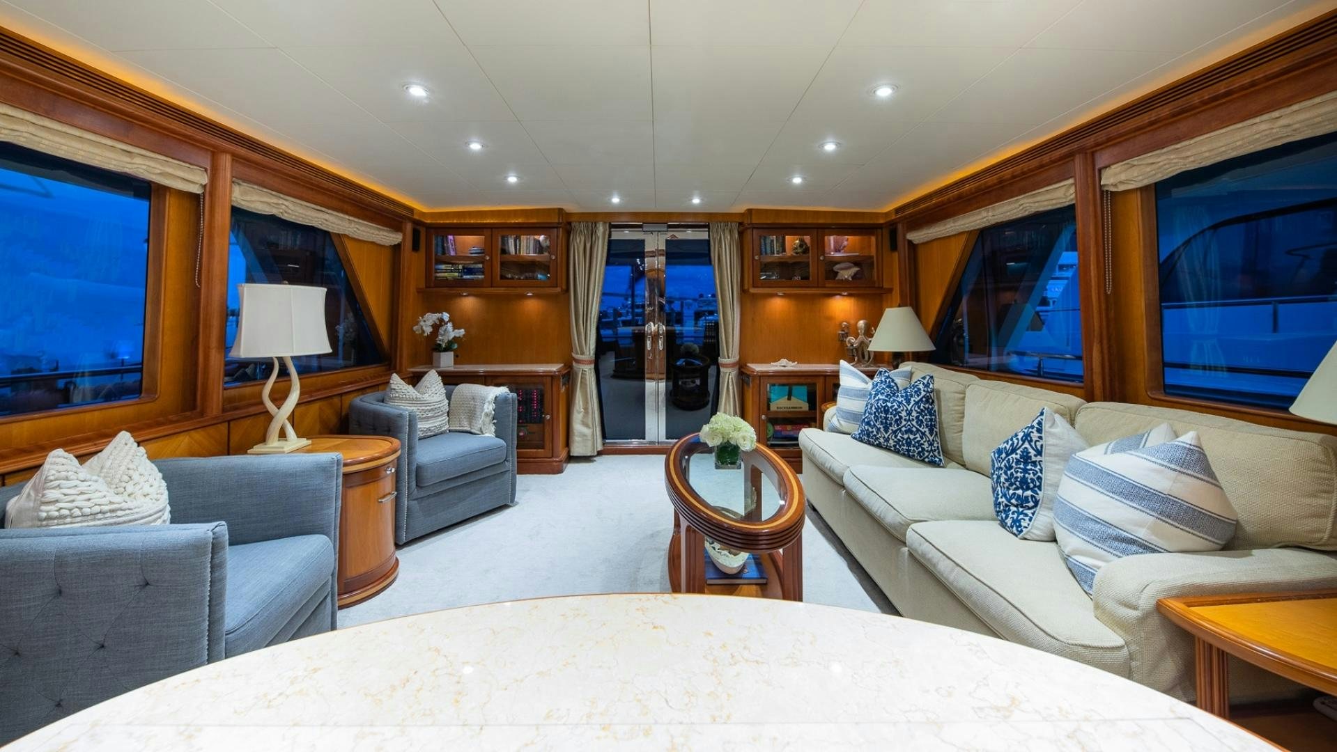 a large living room with a large white bed and a large window aboard MAGICAL DAYS Yacht for Sale