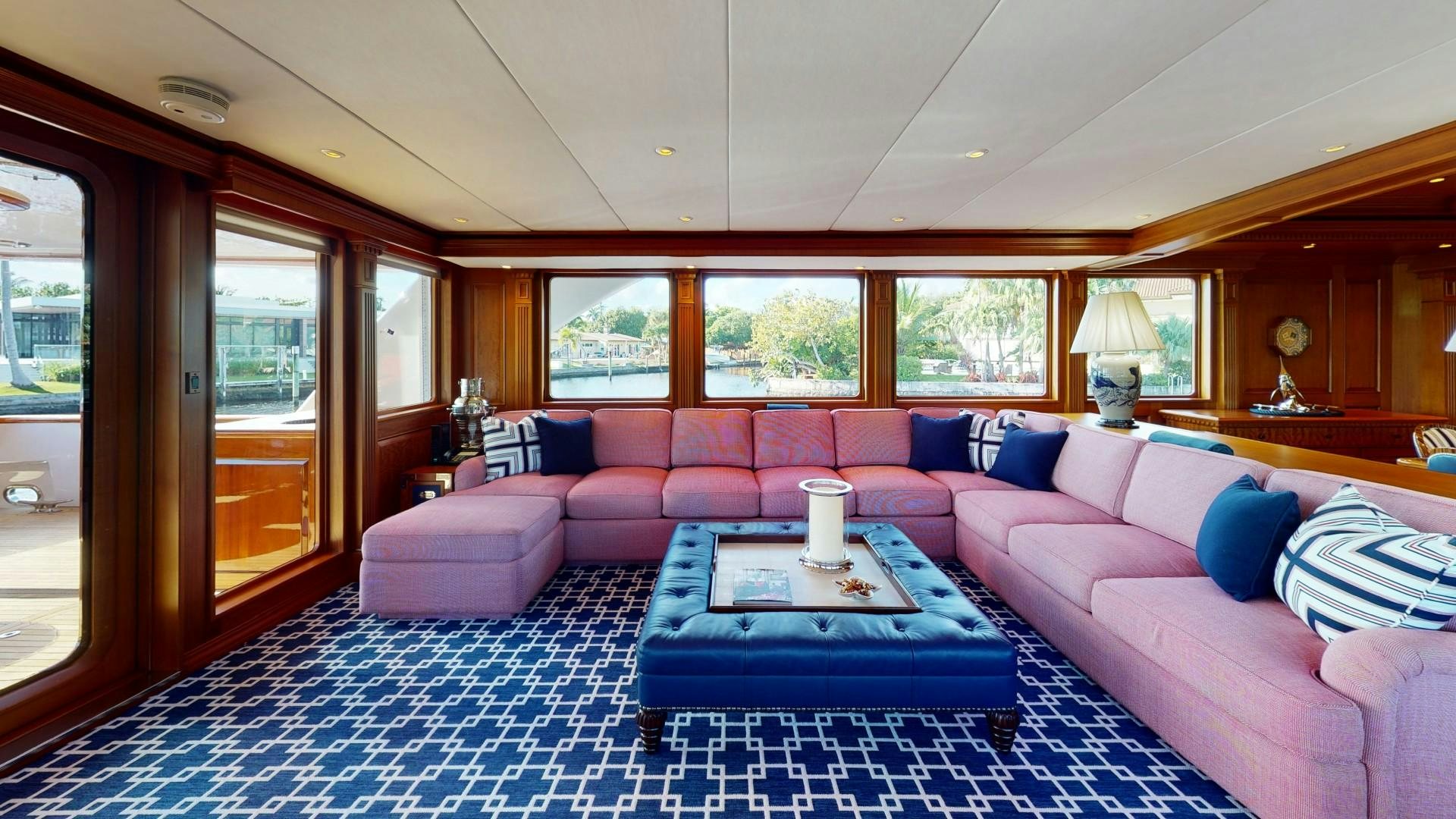 a living room with a blue rug aboard PATRIOT Yacht for Sale