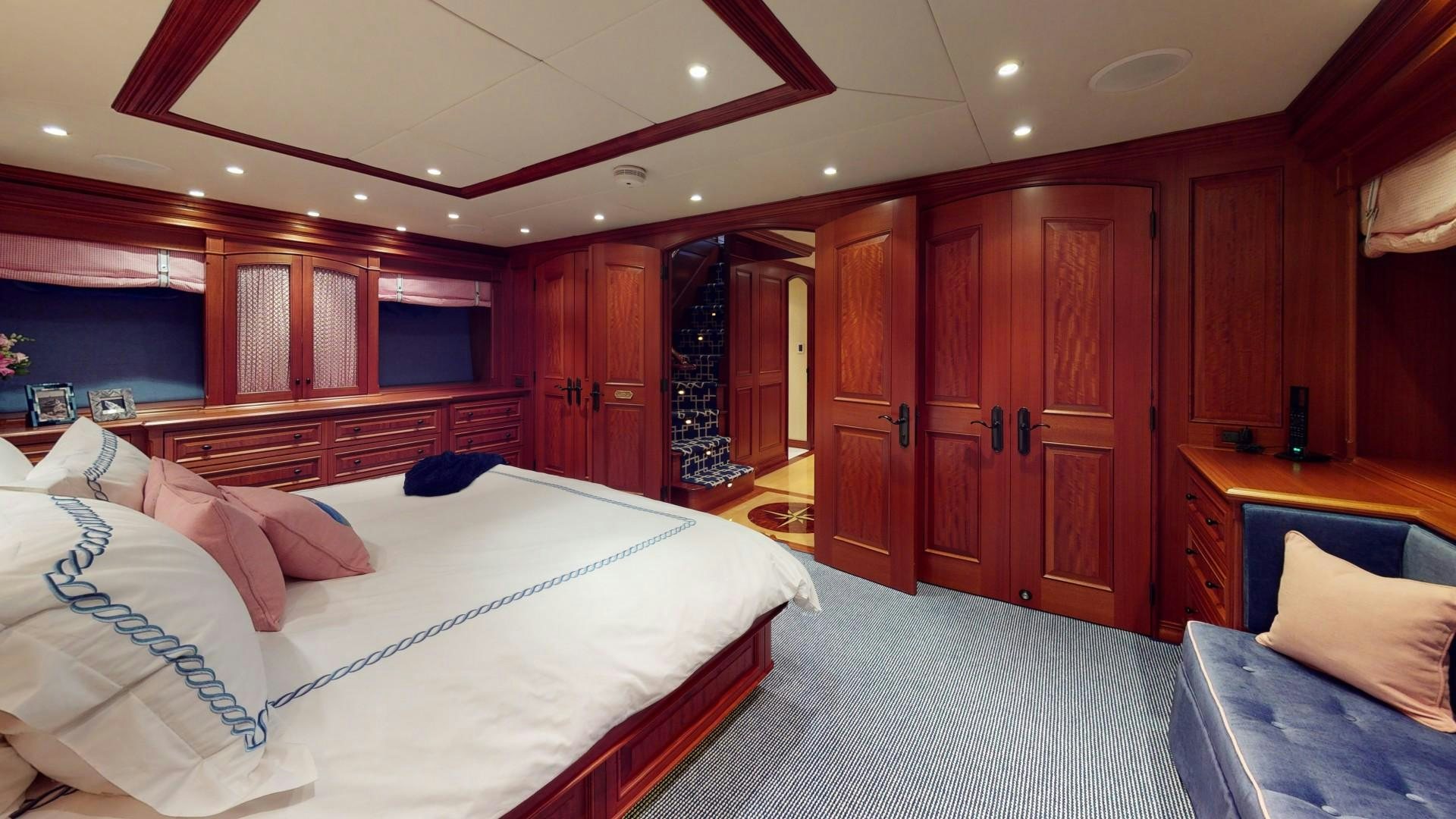 a room with a bed and a closet aboard PATRIOT Yacht for Sale