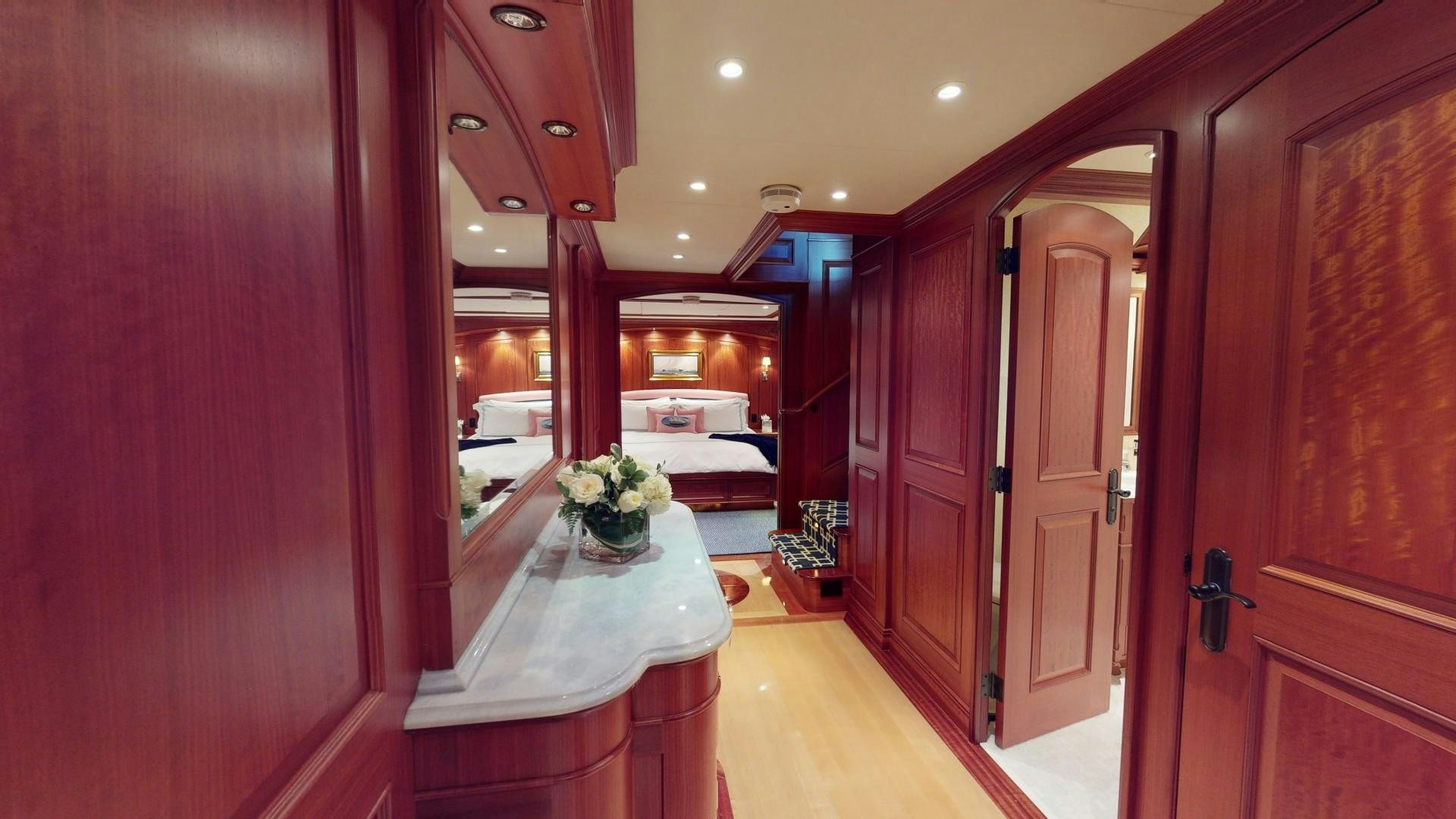 a room with a table and chairs aboard PATRIOT Yacht for Sale