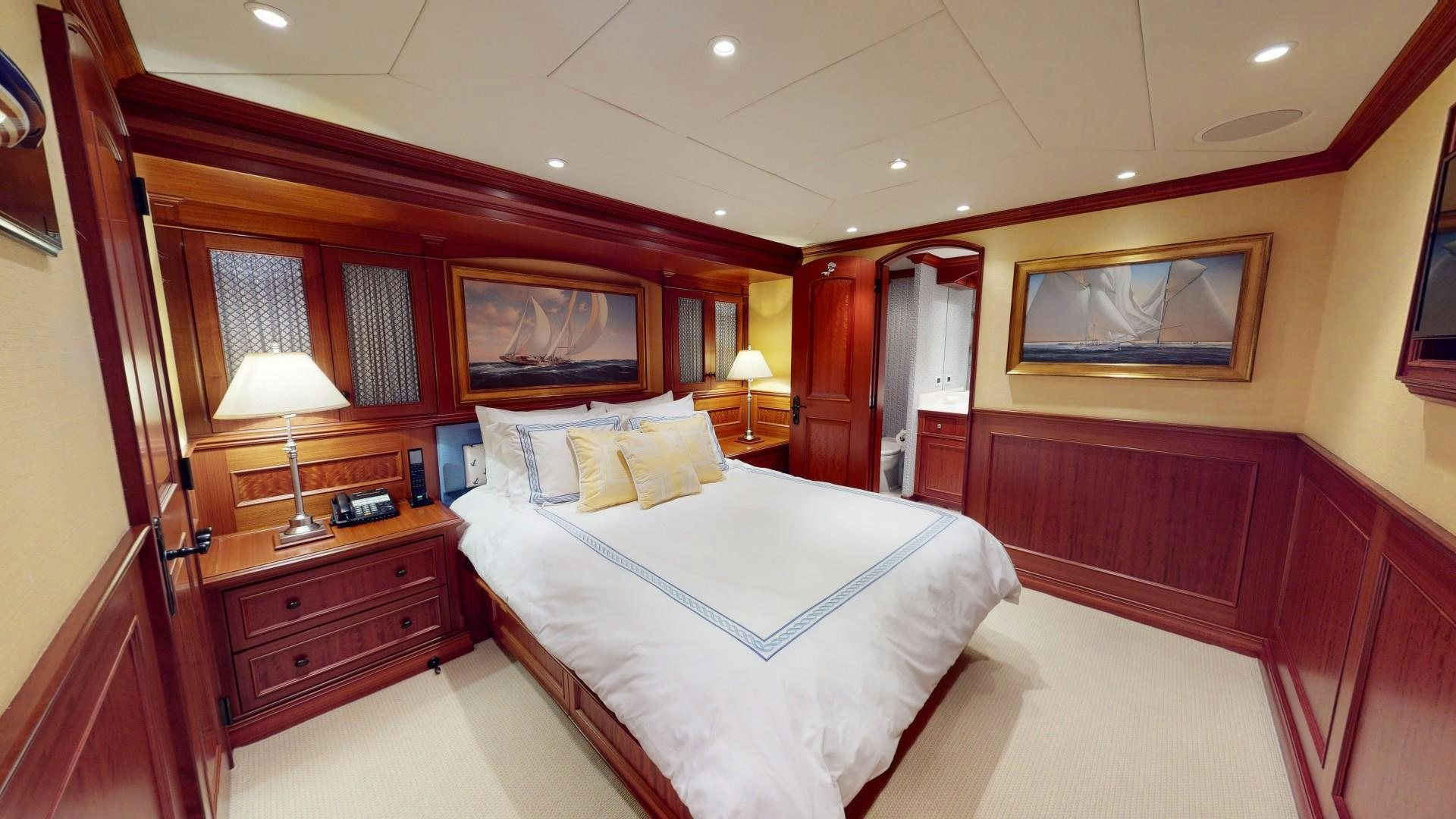 a room with a bed and a desk aboard PATRIOT Yacht for Sale