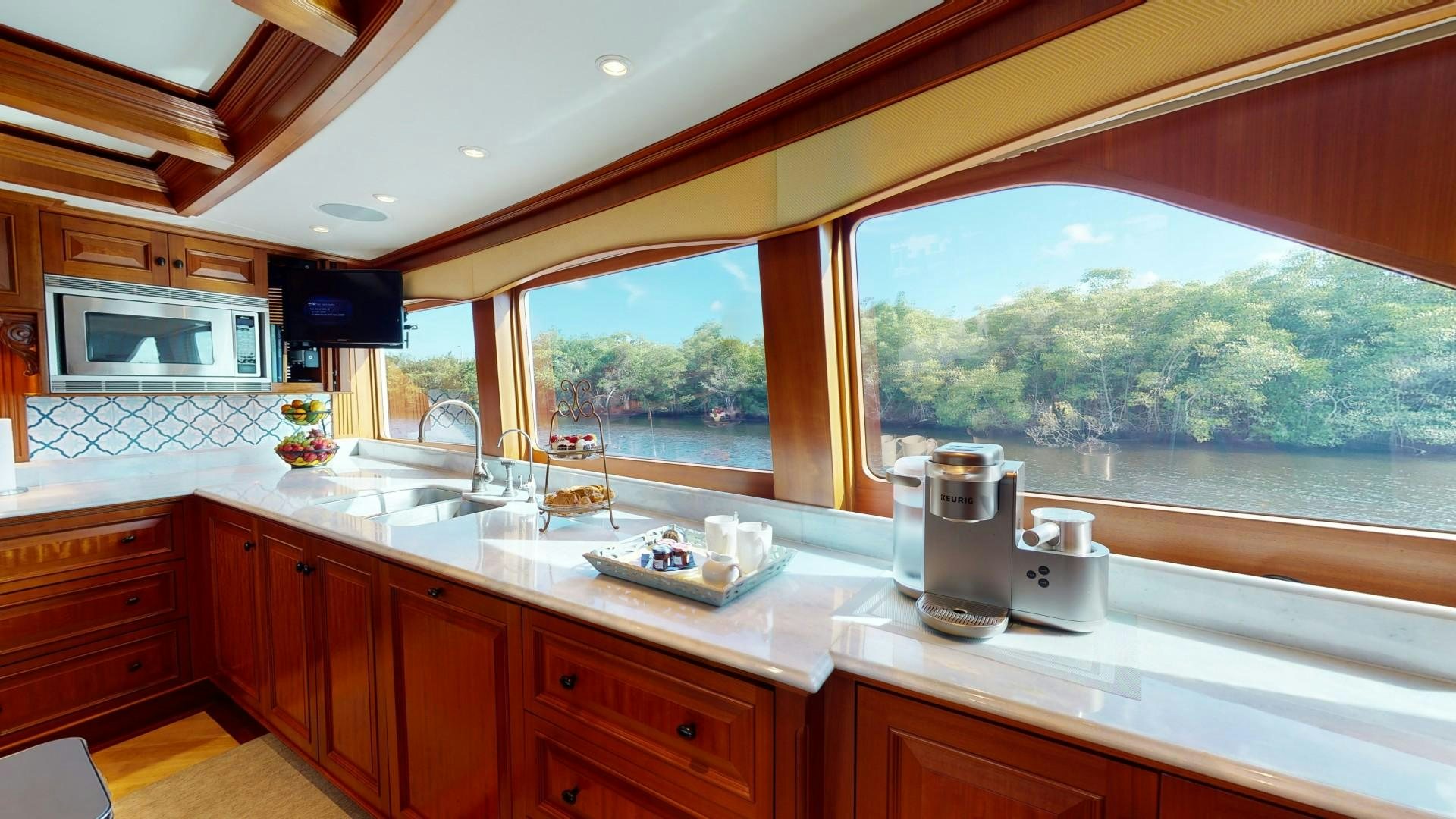 a kitchen with a large window aboard PATRIOT Yacht for Sale