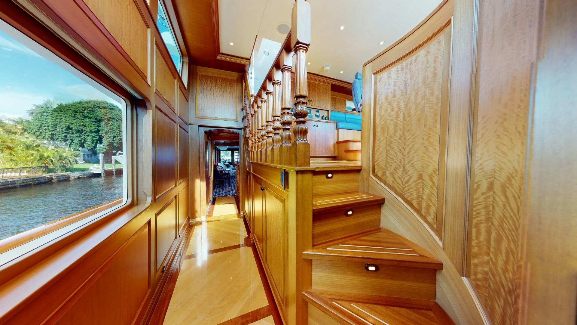 a wood staircase in a room aboard PATRIOT Yacht for Sale