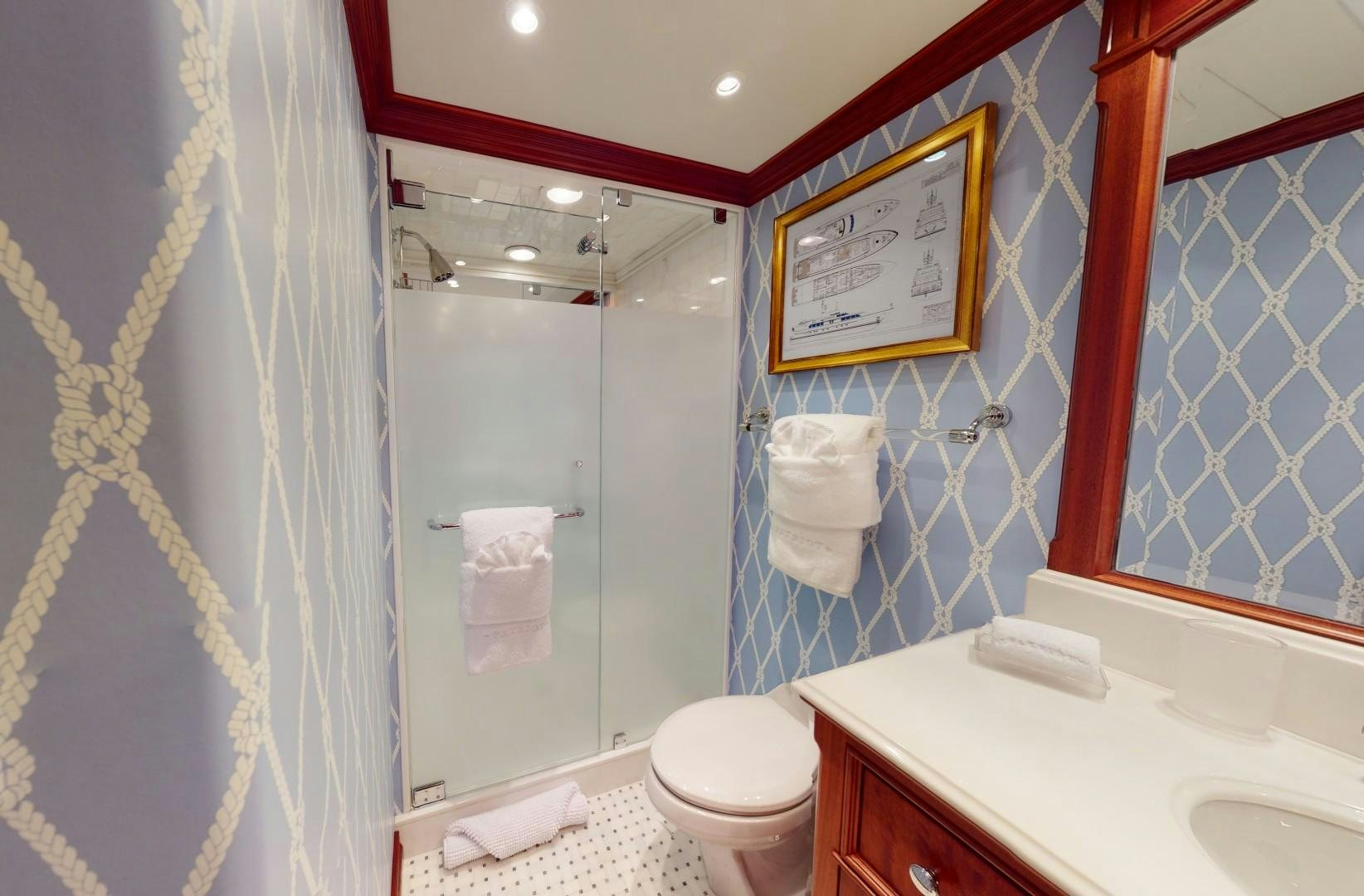 a bathroom with a toilet and a sink aboard PATRIOT Yacht for Sale