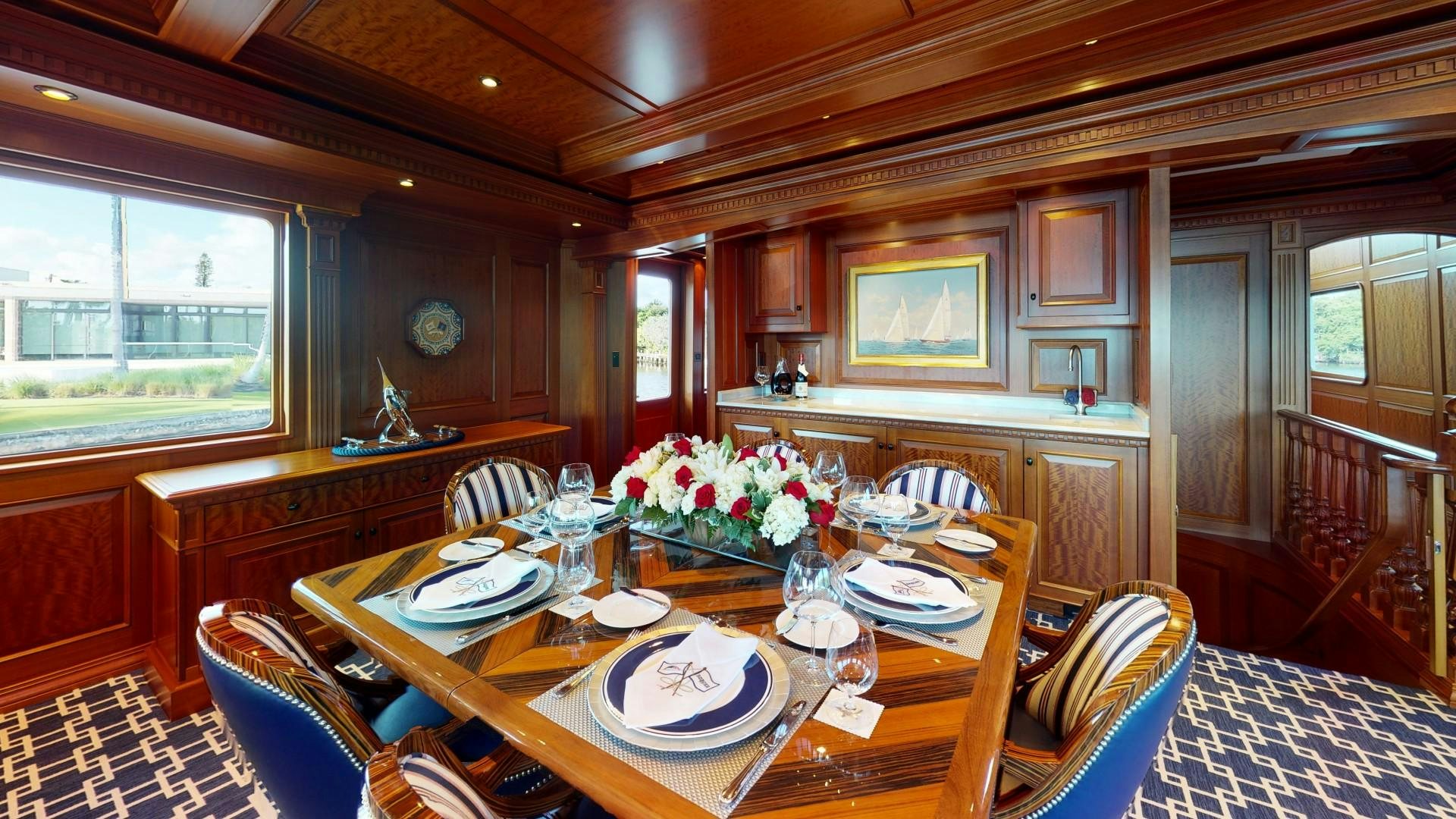 a dining room with a table and chairs aboard PATRIOT Yacht for Sale