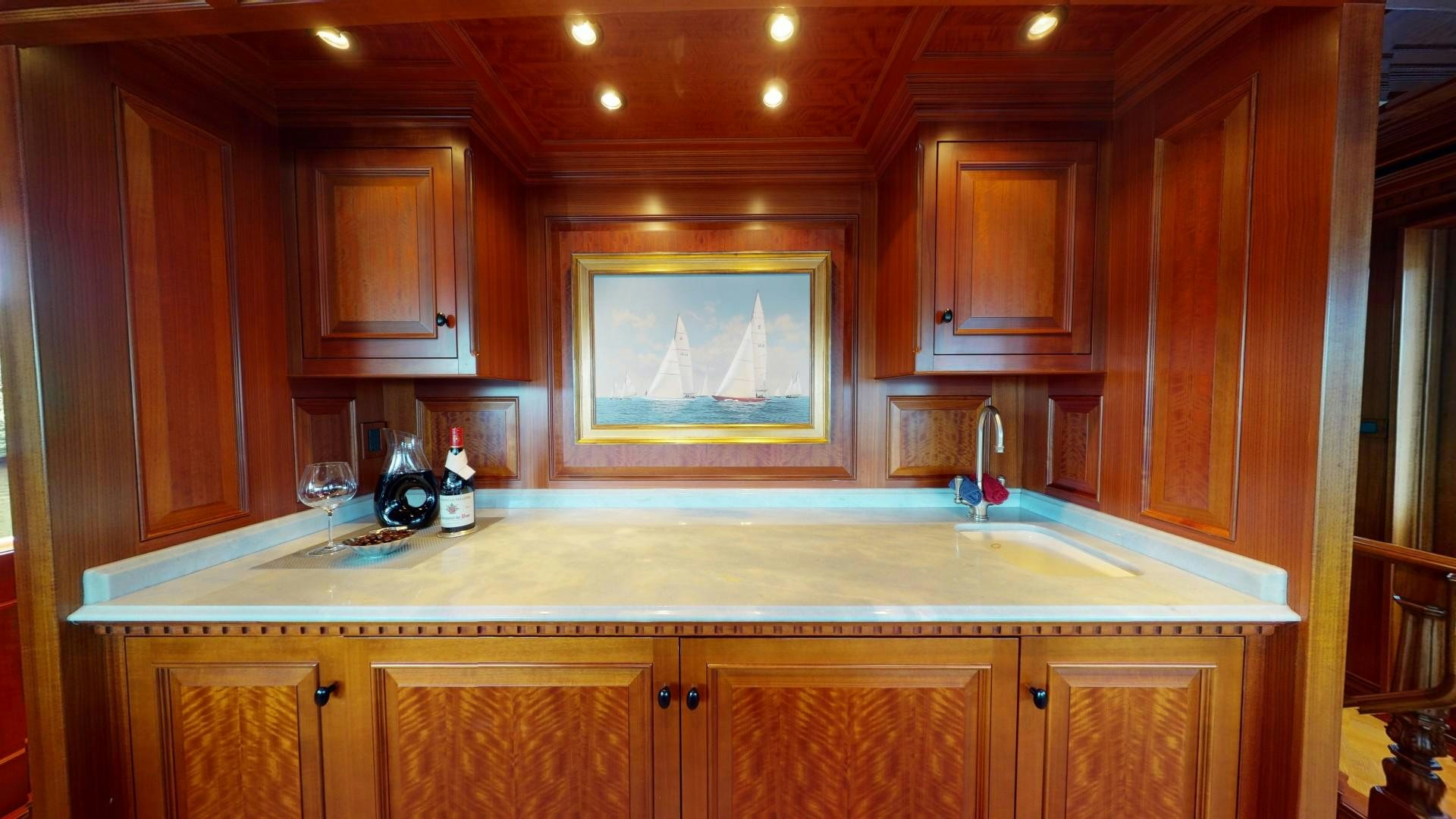a kitchen with wooden cabinets aboard PATRIOT Yacht for Sale