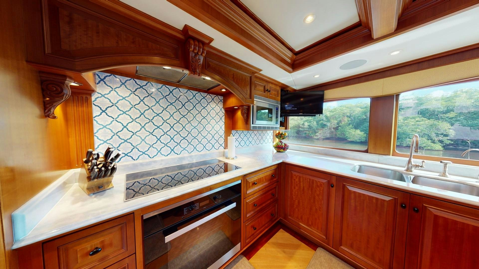 a kitchen with wooden cabinets aboard PATRIOT Yacht for Sale