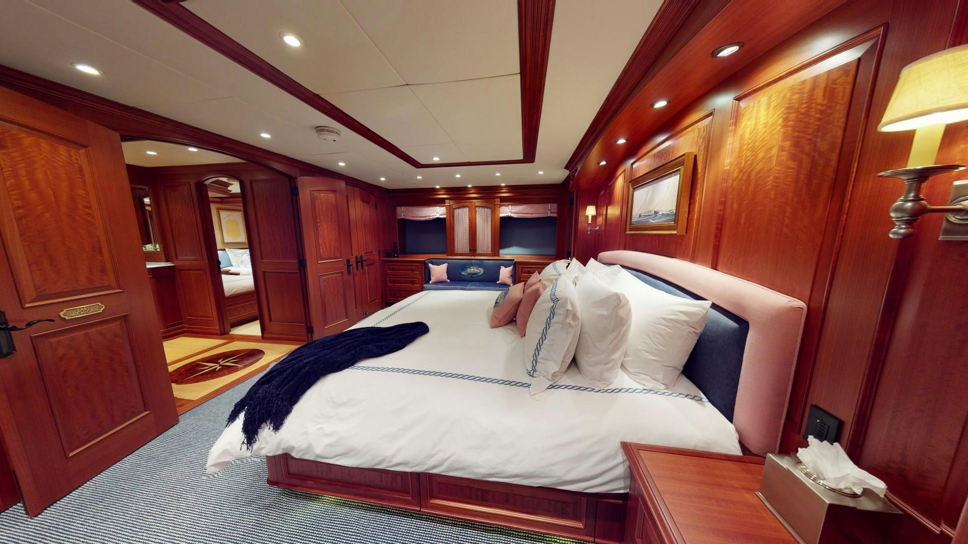 a bedroom with a large bed aboard PATRIOT Yacht for Sale