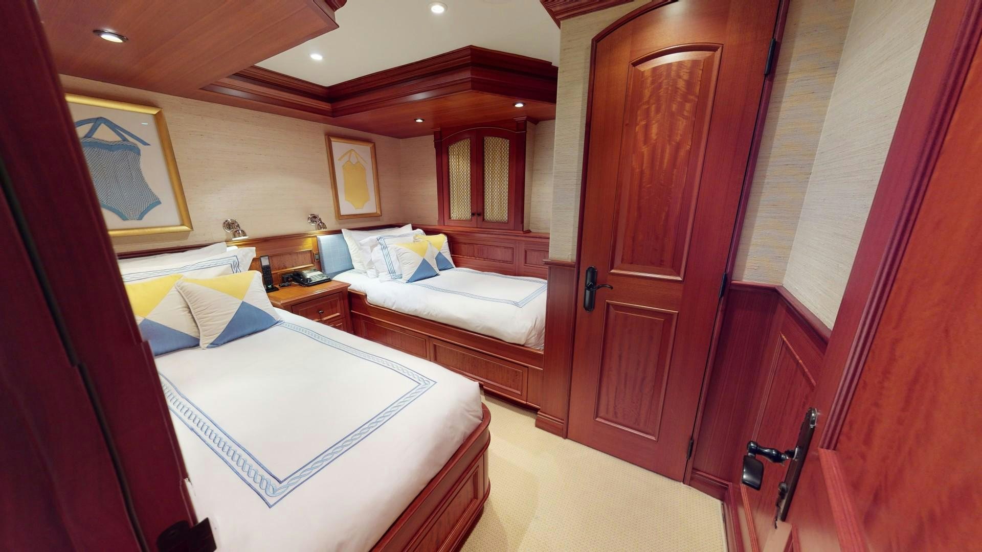 a room with two beds aboard PATRIOT Yacht for Sale