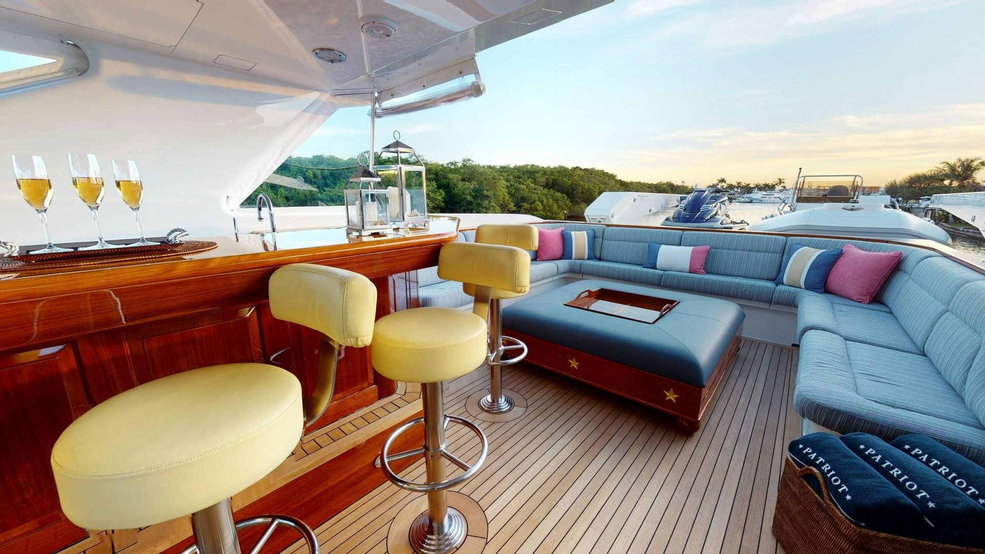 a room with a couch and a table with chairs and a table aboard PATRIOT Yacht for Sale