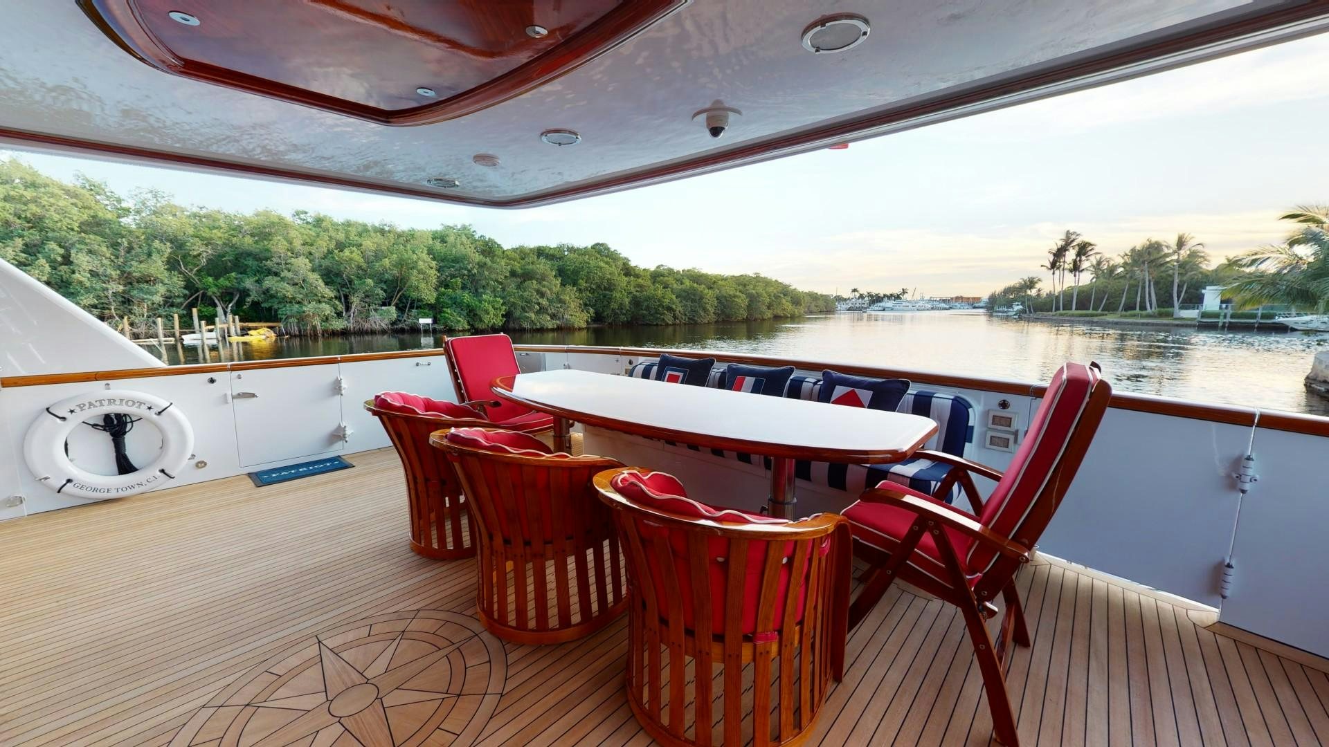 a table and chairs on a deck aboard PATRIOT Yacht for Sale
