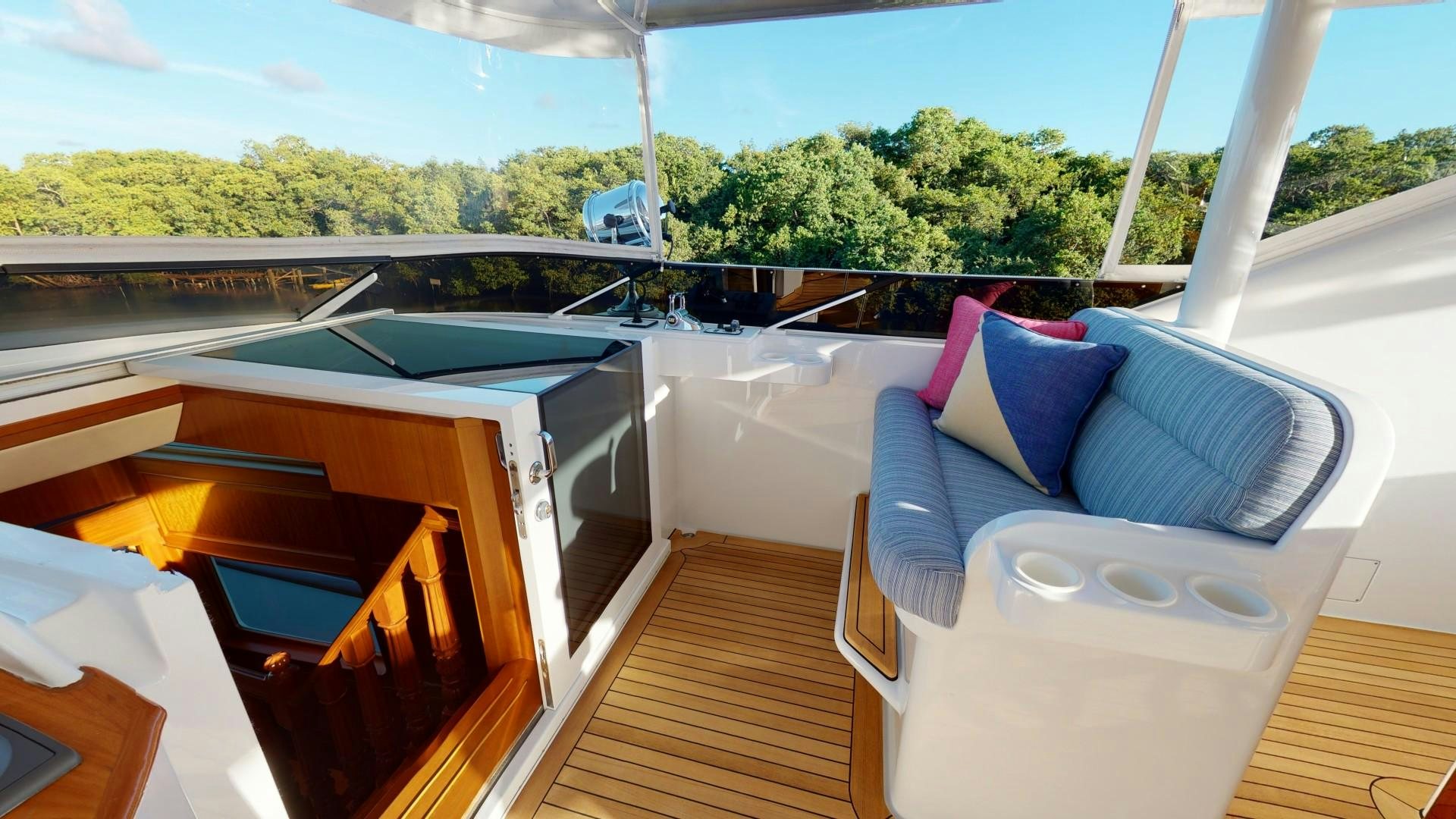a room with a bed and a table and a window aboard PATRIOT Yacht for Sale