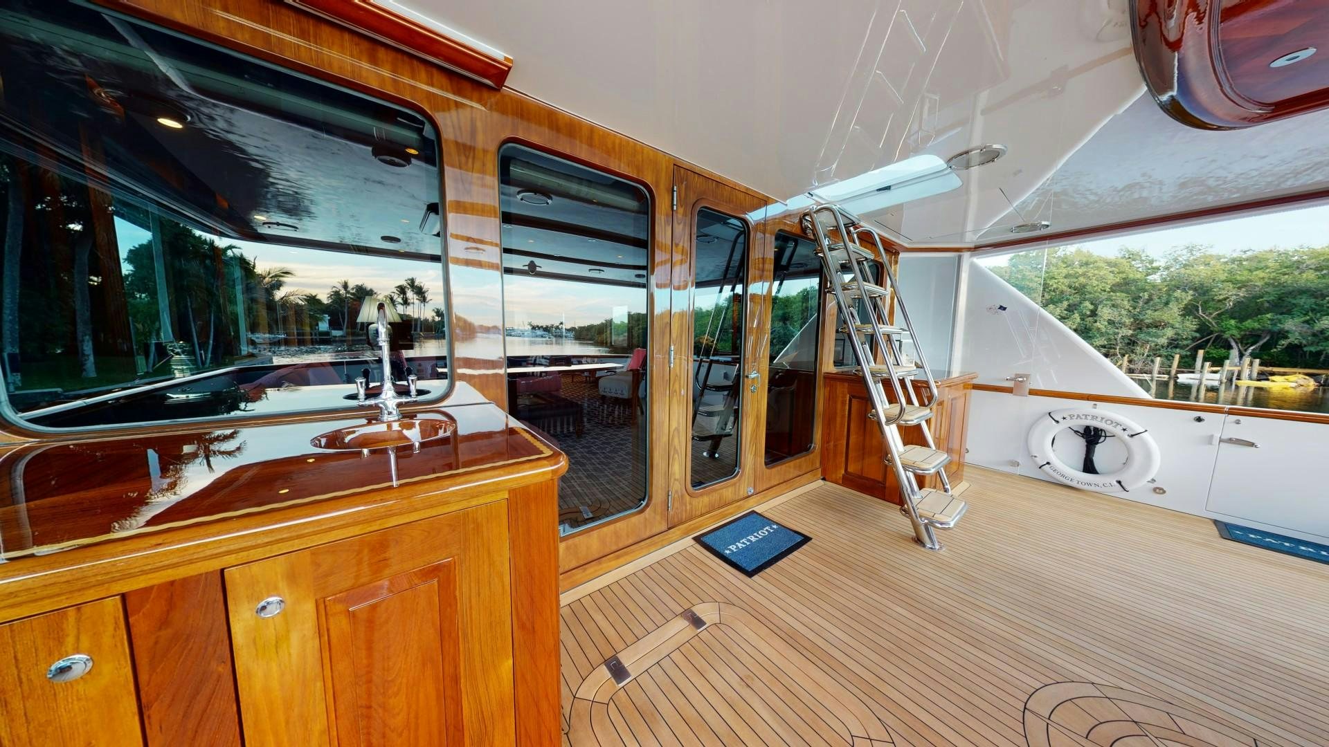a room with a large window and a wood floor aboard PATRIOT Yacht for Sale