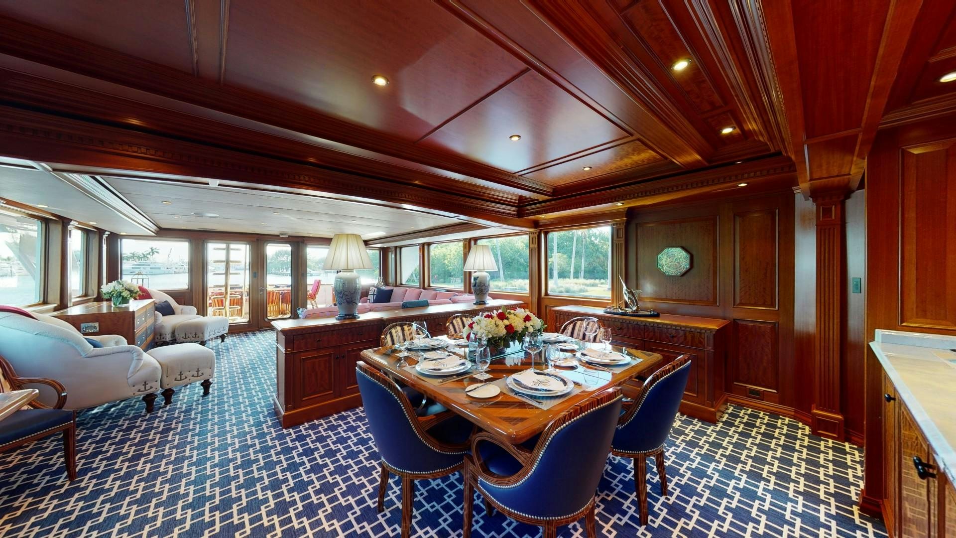 a large dining room with a large table and chairs aboard PATRIOT Yacht for Sale