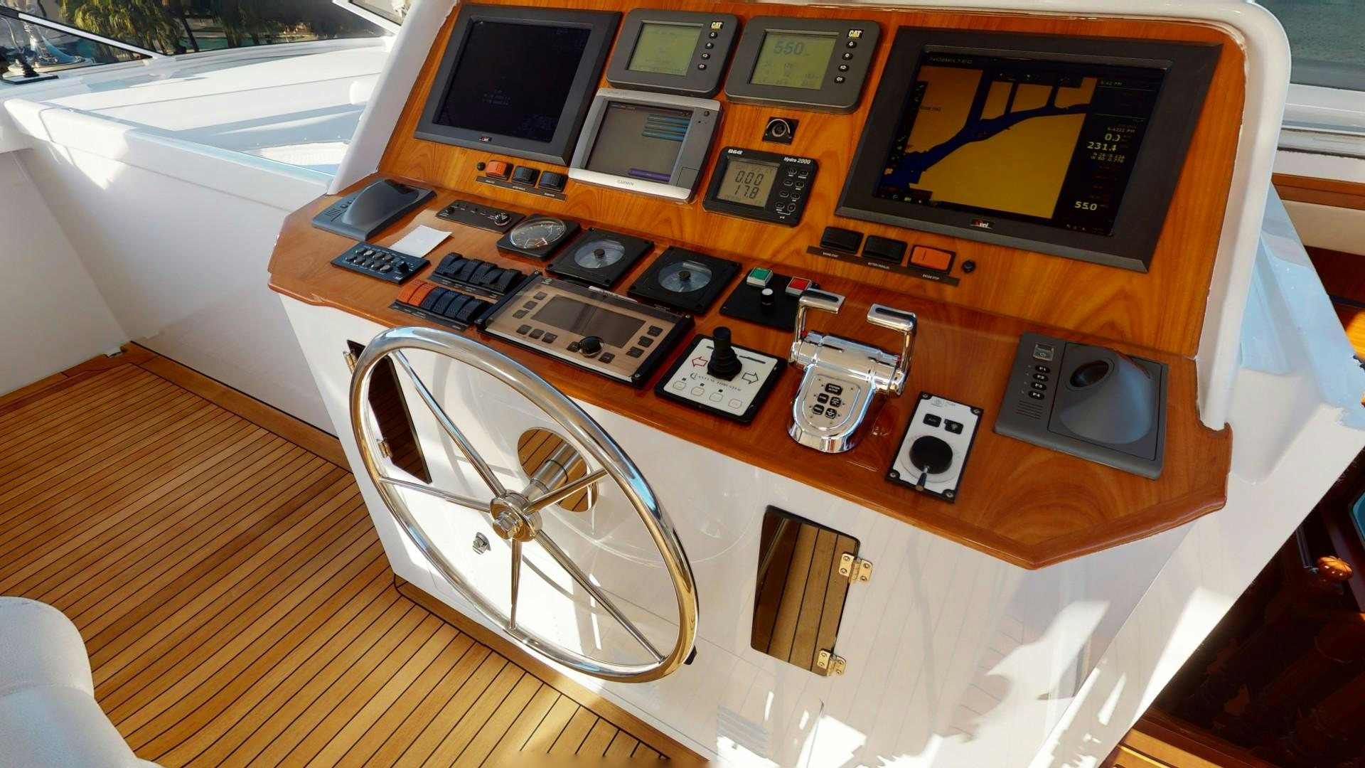 a wooden desk with a fan and electronics on it aboard PATRIOT Yacht for Sale