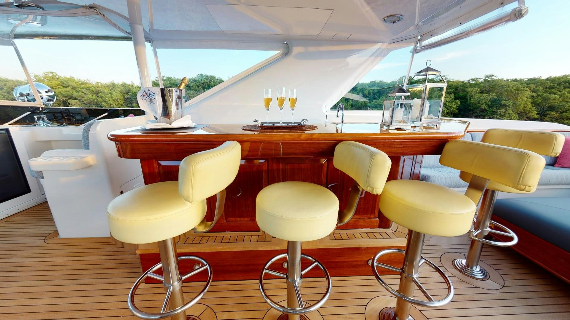a table with chairs and a laptop on it aboard PATRIOT Yacht for Sale