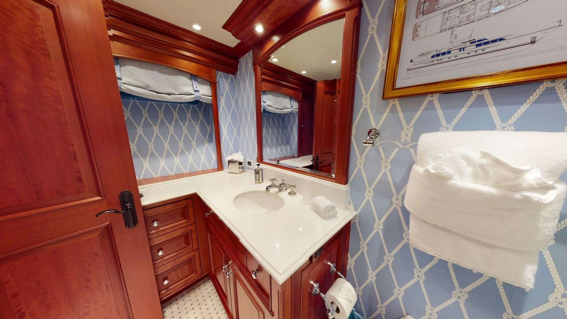 a bathroom with a sink and mirror aboard PATRIOT Yacht for Sale