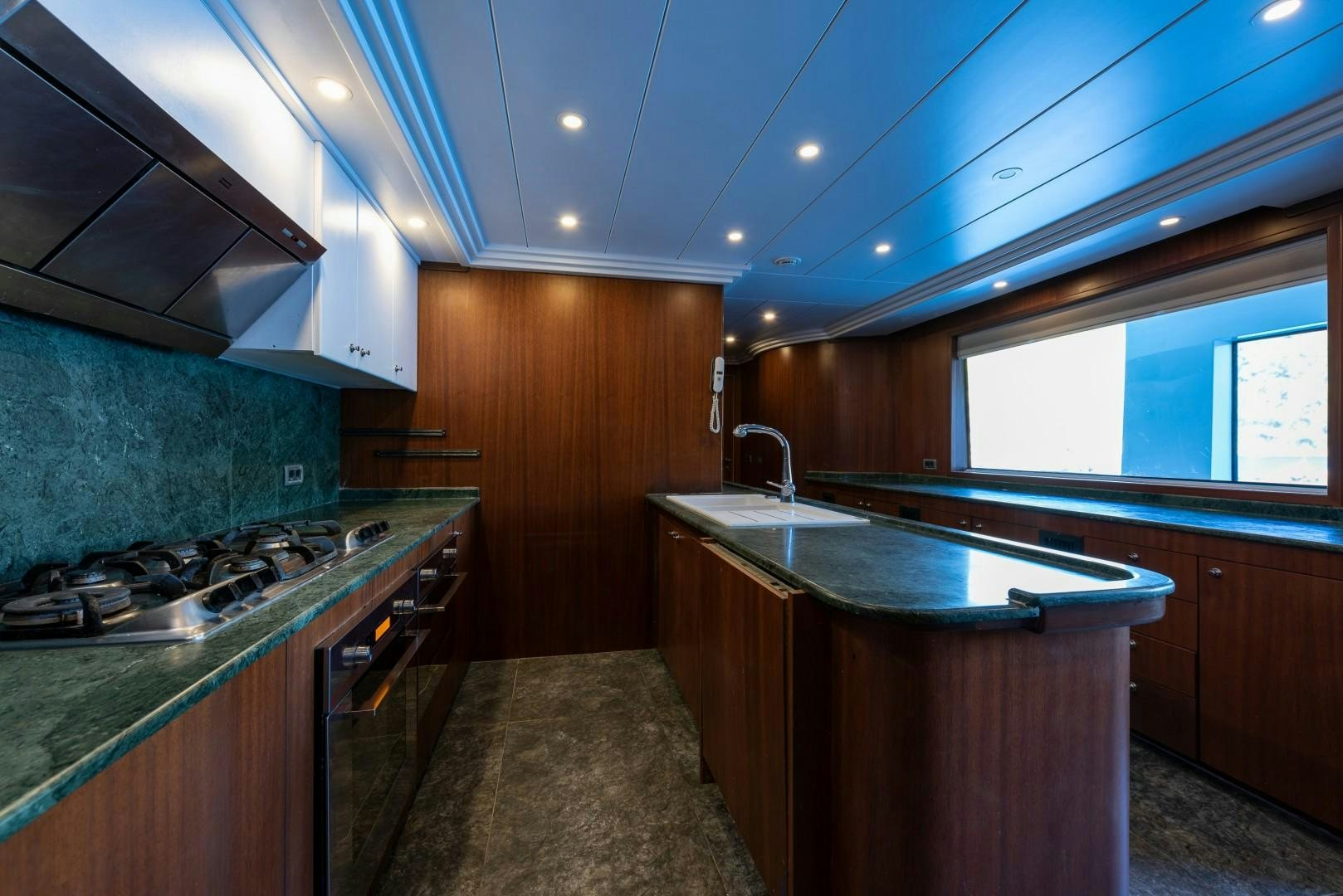 a kitchen with a stove and a sink aboard OCEAN BREEZE Yacht for Sale
