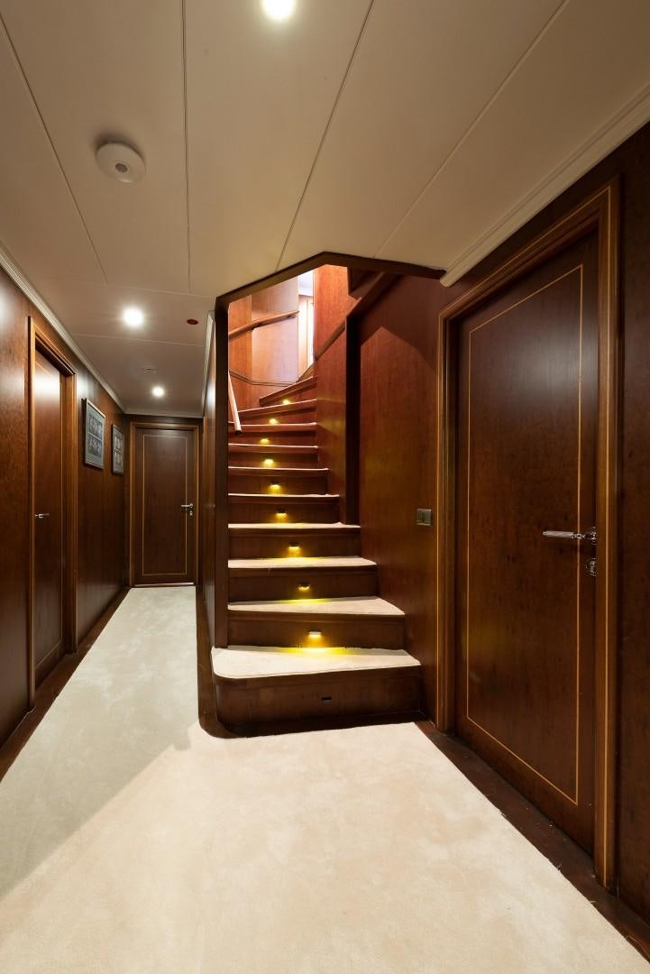 a long hallway with a set of doors and a staircase aboard OCEAN BREEZE Yacht for Sale