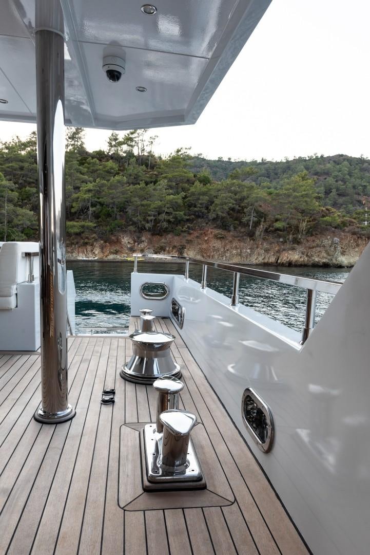 a deck with a view of the water and trees aboard OCEAN BREEZE Yacht for Sale