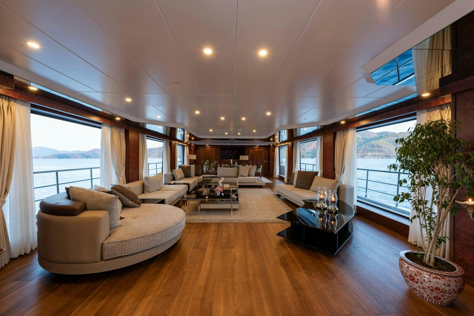 a living room with a wood floor aboard OCEAN BREEZE Yacht for Sale
