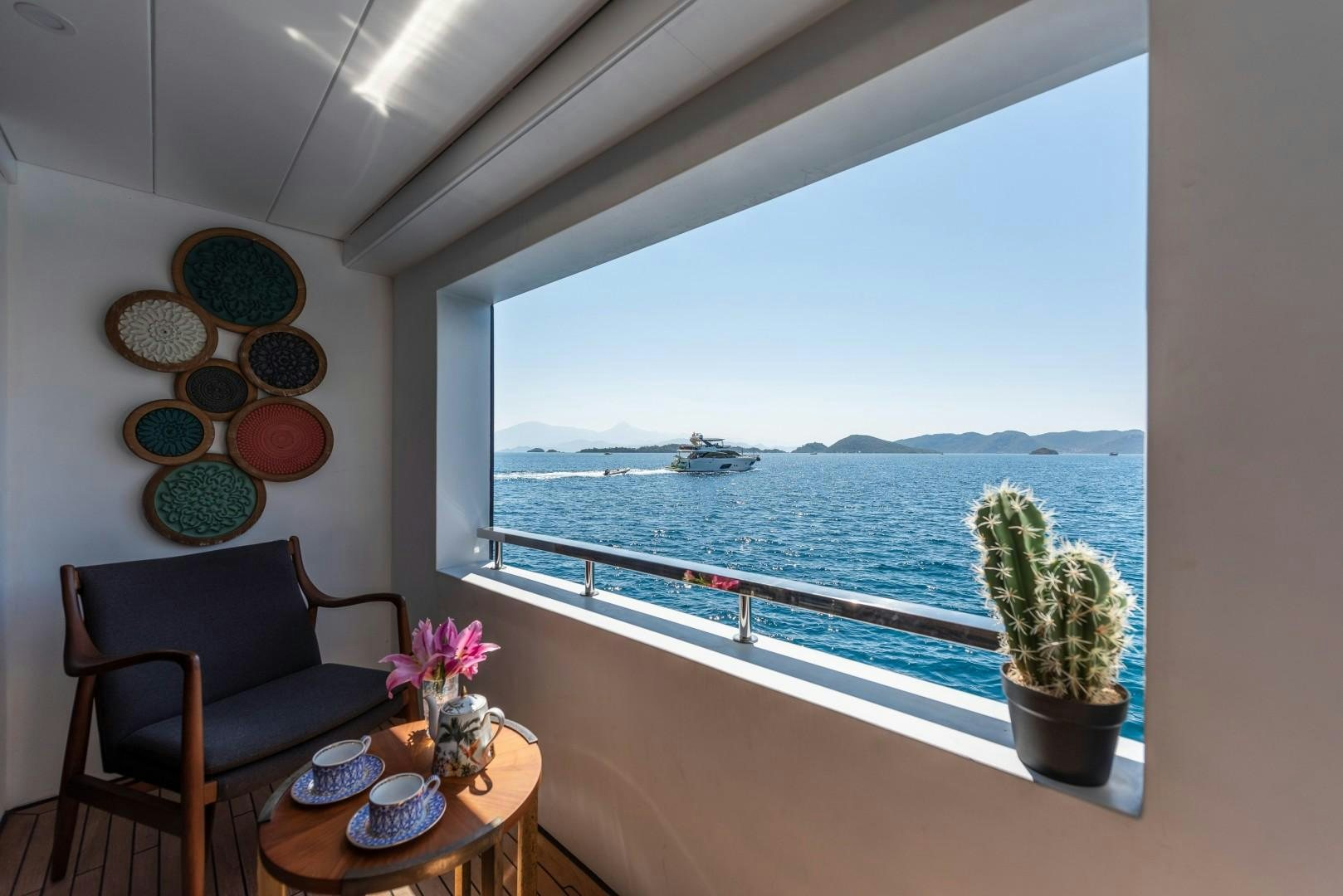 a table and chairs in a room aboard OCEAN BREEZE Yacht for Sale