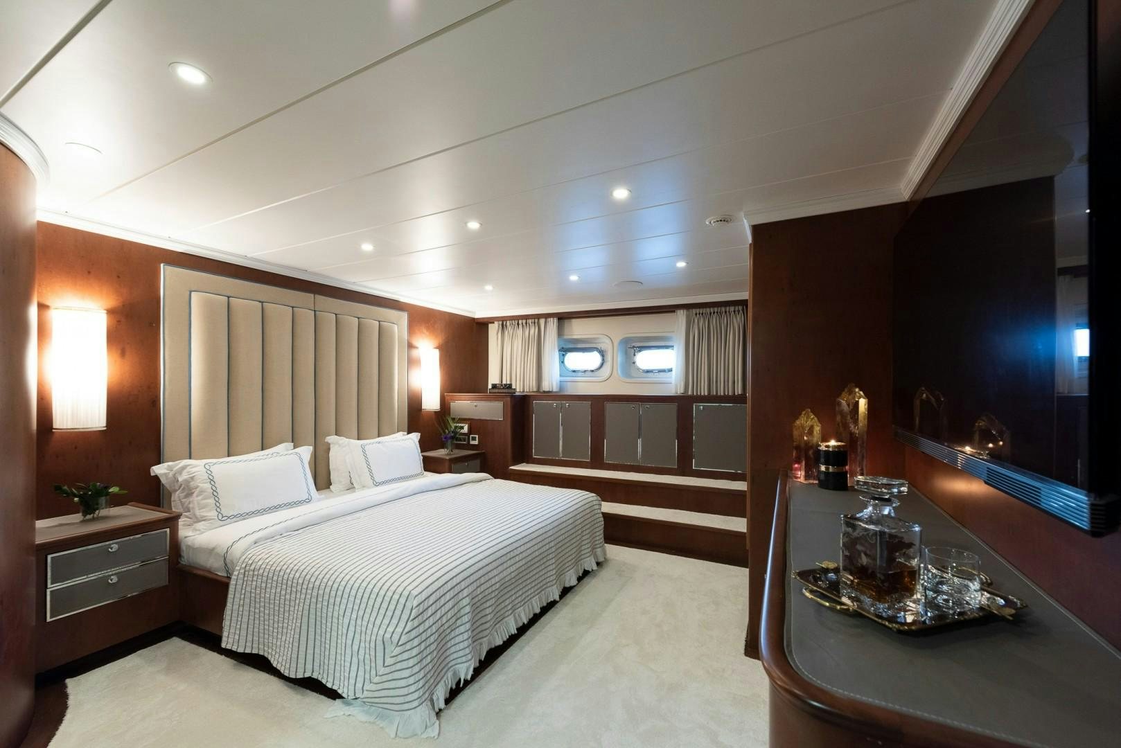 a room with a bed and a table aboard OCEAN BREEZE Yacht for Sale