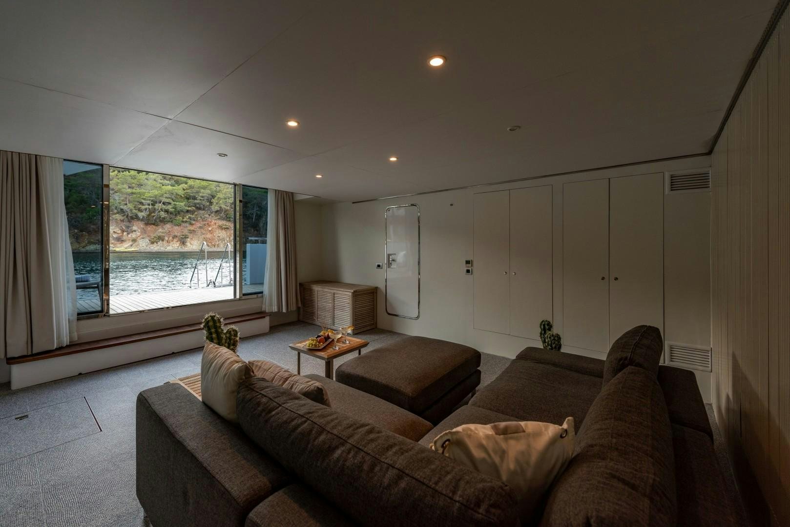 a living room with a couch and a table aboard OCEAN BREEZE Yacht for Sale