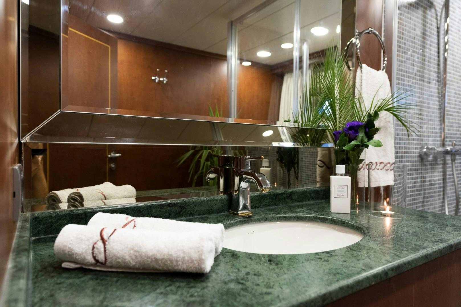 a bathroom with a large mirror aboard OCEAN BREEZE Yacht for Sale