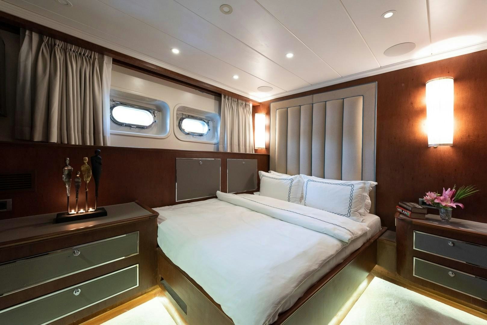 a room with a bed and a desk aboard OCEAN BREEZE Yacht for Sale