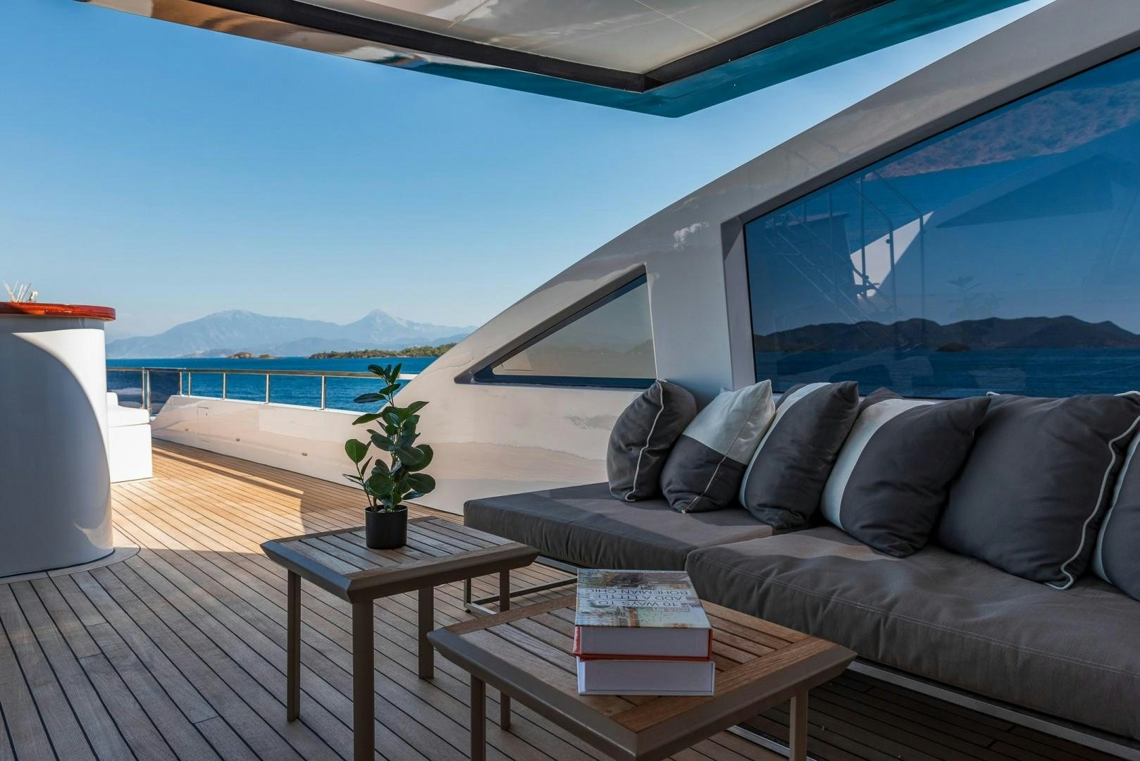a living room with a couch and a table aboard OCEAN BREEZE Yacht for Sale