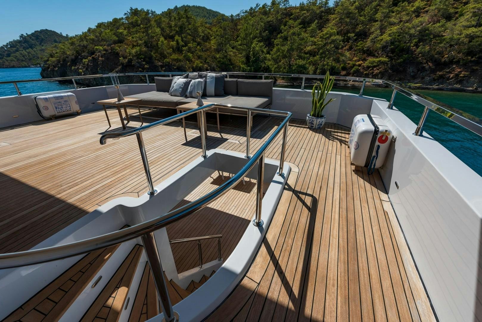 a deck with a deck and a pool aboard OCEAN BREEZE Yacht for Sale
