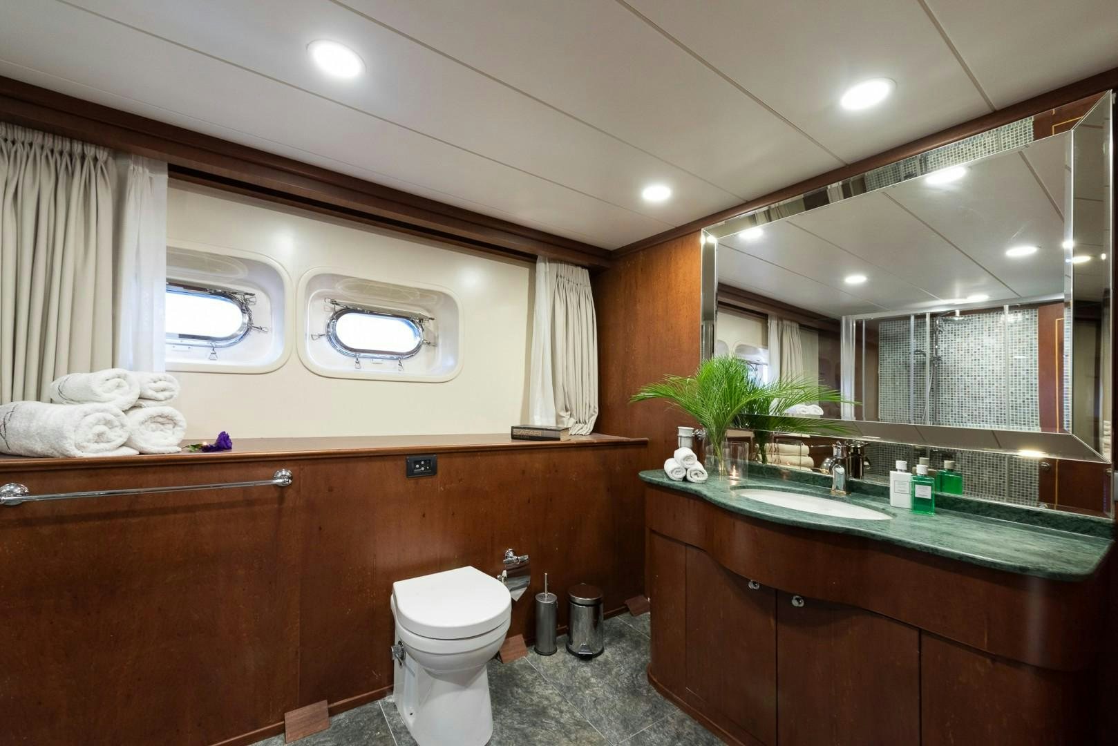 a bathroom with a large mirror aboard OCEAN BREEZE Yacht for Sale