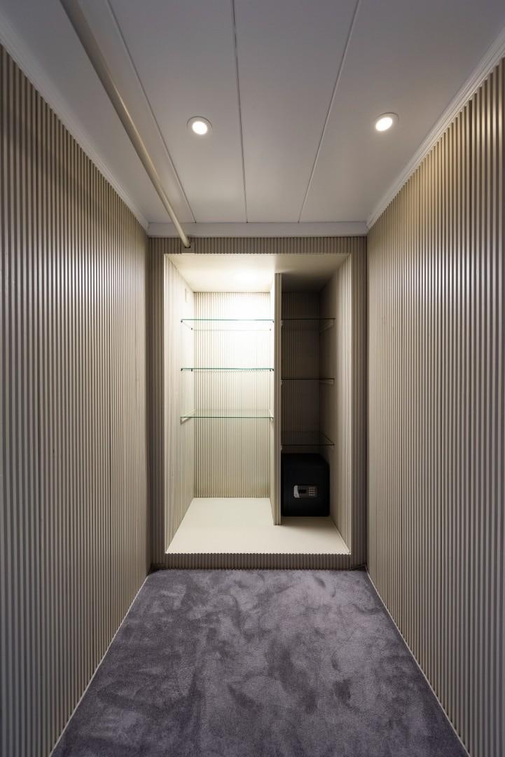 a room with a bed and a closet aboard OCEAN BREEZE Yacht for Sale