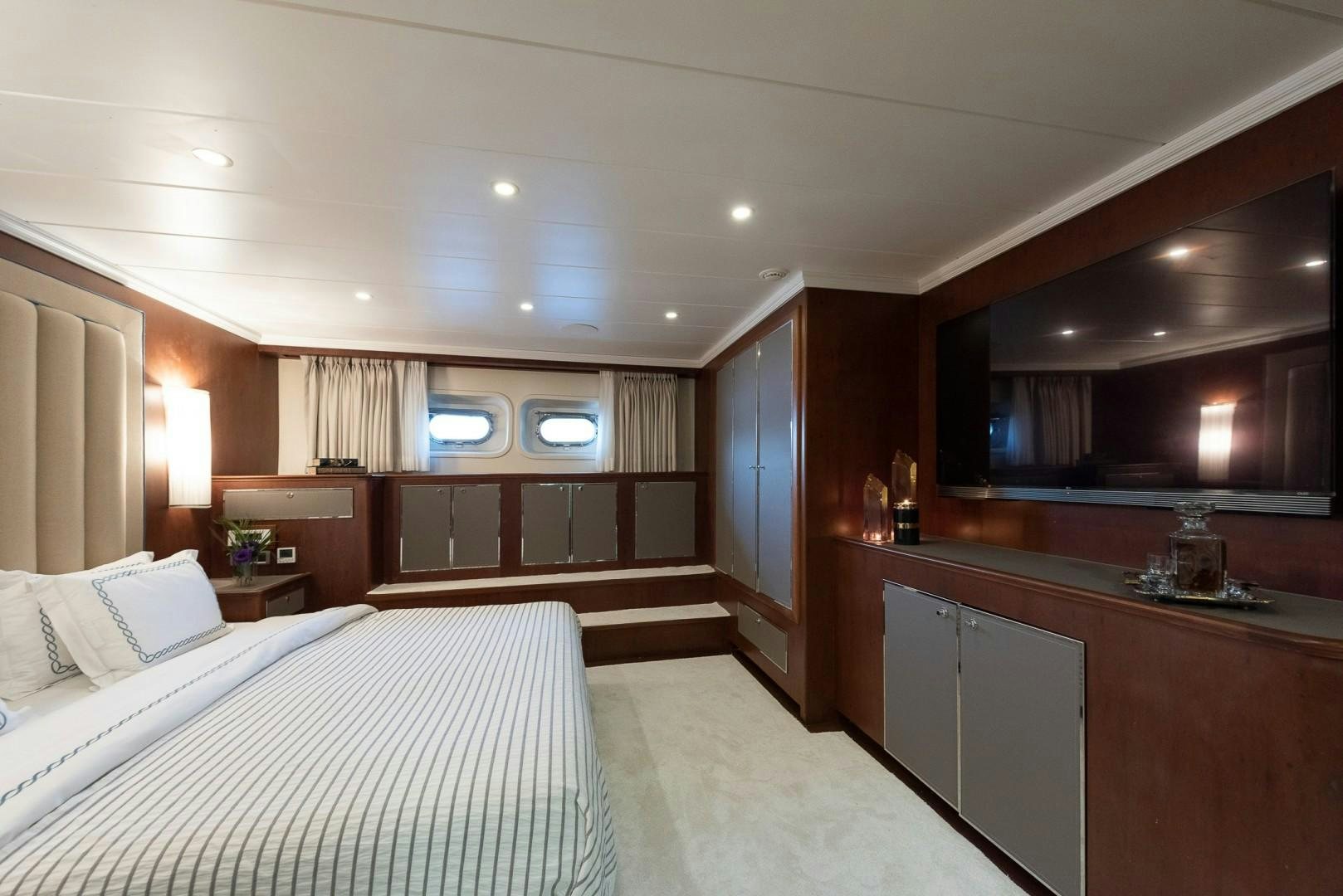 a bedroom with a bed and a desk aboard OCEAN BREEZE Yacht for Sale