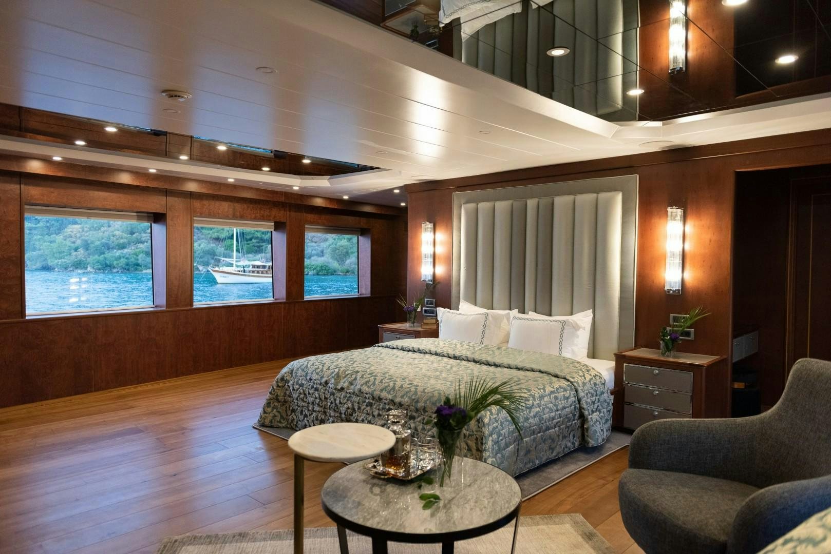 a bedroom with a bed and a table aboard OCEAN BREEZE Yacht for Sale