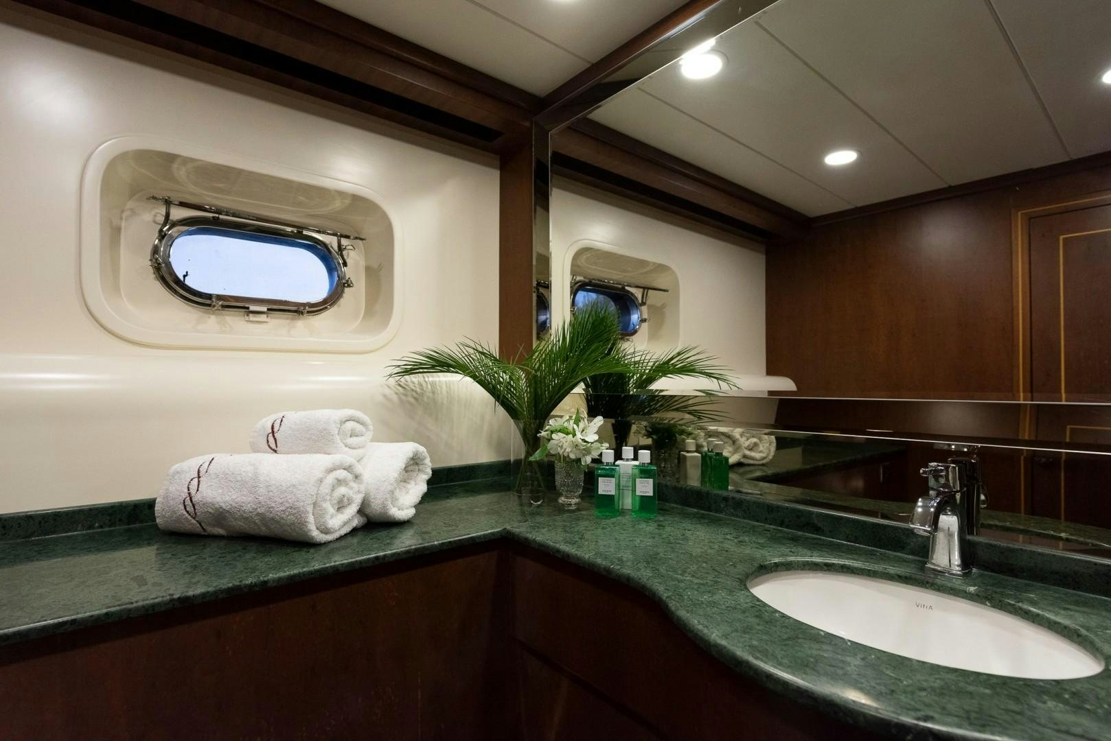 a bathroom with a large mirror aboard OCEAN BREEZE Yacht for Sale