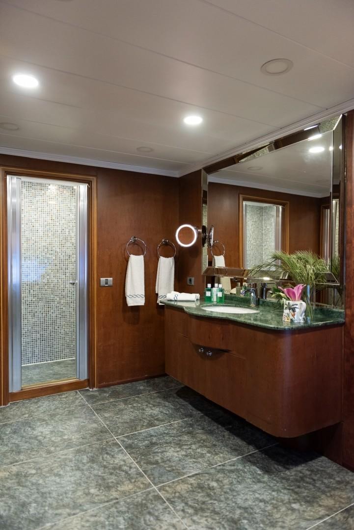 a bathroom with a large mirror aboard OCEAN BREEZE Yacht for Sale
