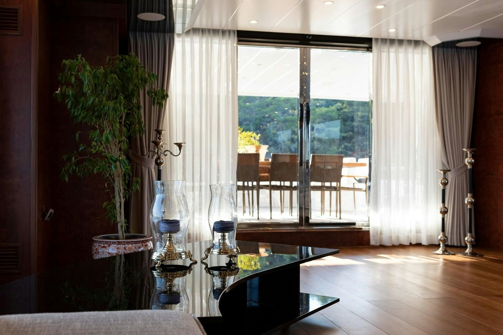 a room with a table and chairs aboard OCEAN BREEZE Yacht for Sale