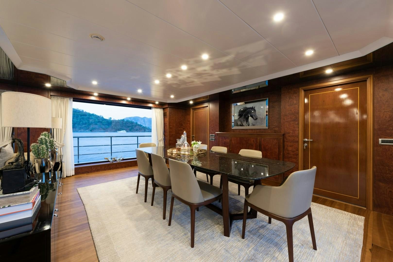 a large dining room with a large window and a large open door aboard OCEAN BREEZE Yacht for Sale