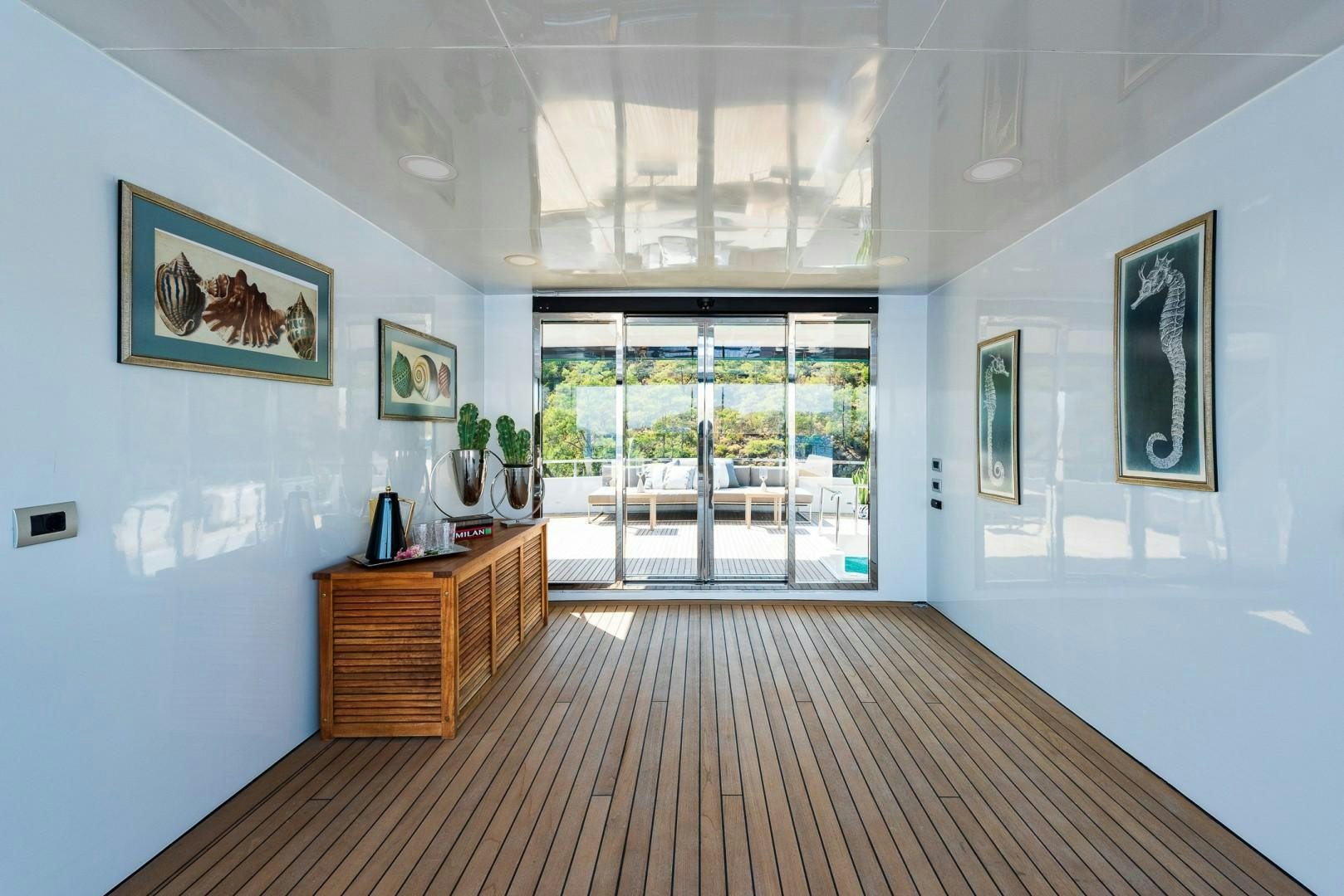 a room with a wood floor and a wood cabinet and a wood cabinet aboard OCEAN BREEZE Yacht for Sale
