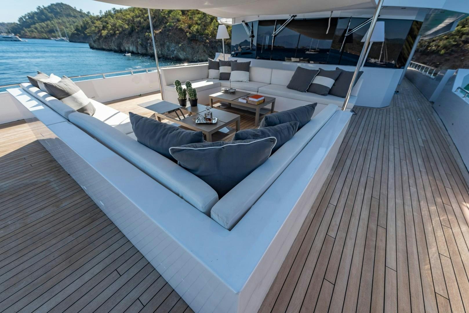 a lounge area with a couch and a table on it aboard OCEAN BREEZE Yacht for Sale