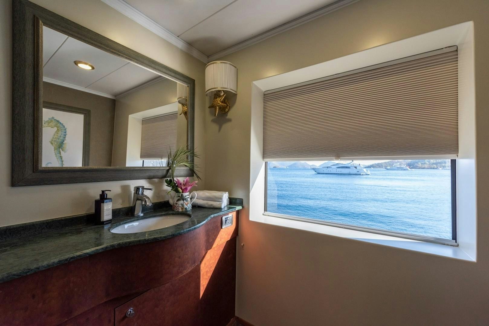 a bathroom with a sink and a mirror aboard OCEAN BREEZE Yacht for Sale