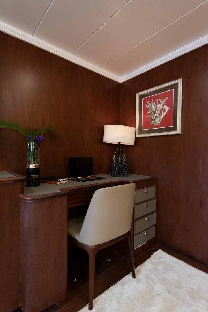 a desk with a laptop and a lamp on it aboard OCEAN BREEZE Yacht for Sale