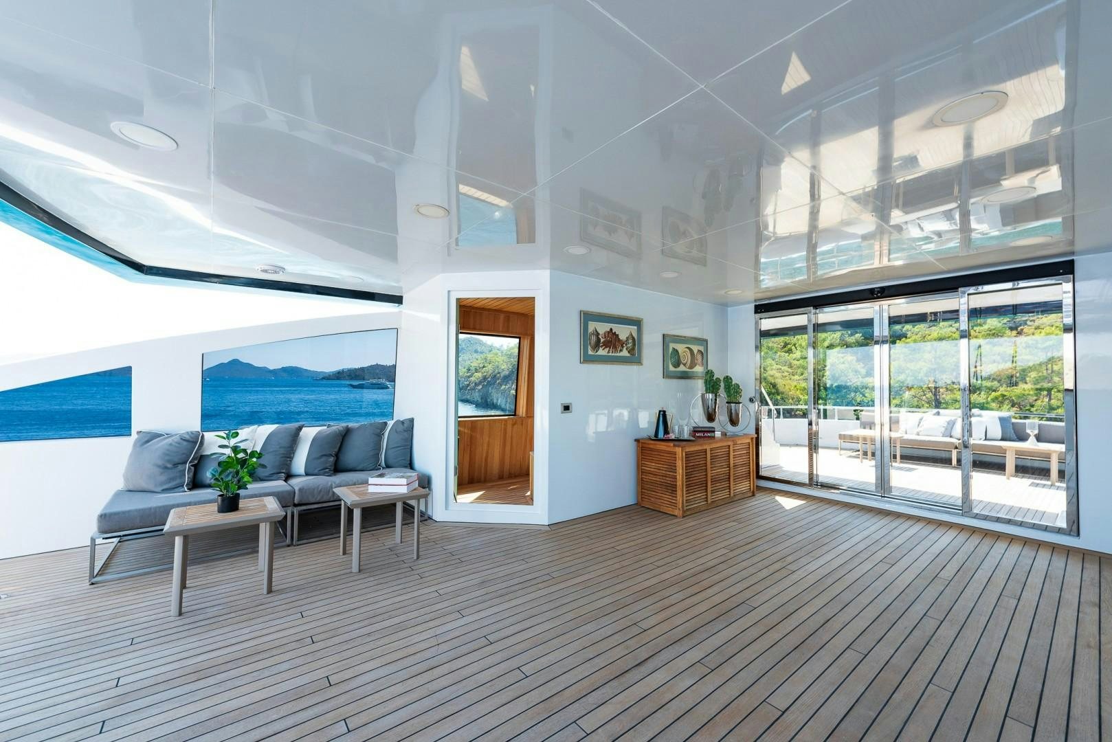 a room with a couch and a table and a window aboard OCEAN BREEZE Yacht for Sale