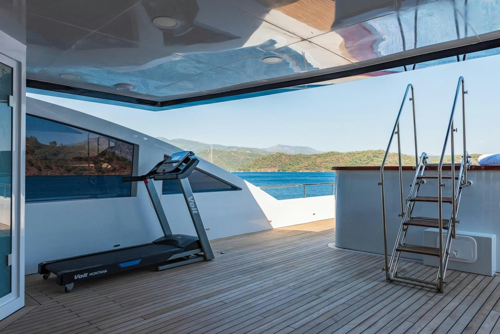 a deck with a slide and a pool aboard OCEAN BREEZE Yacht for Sale