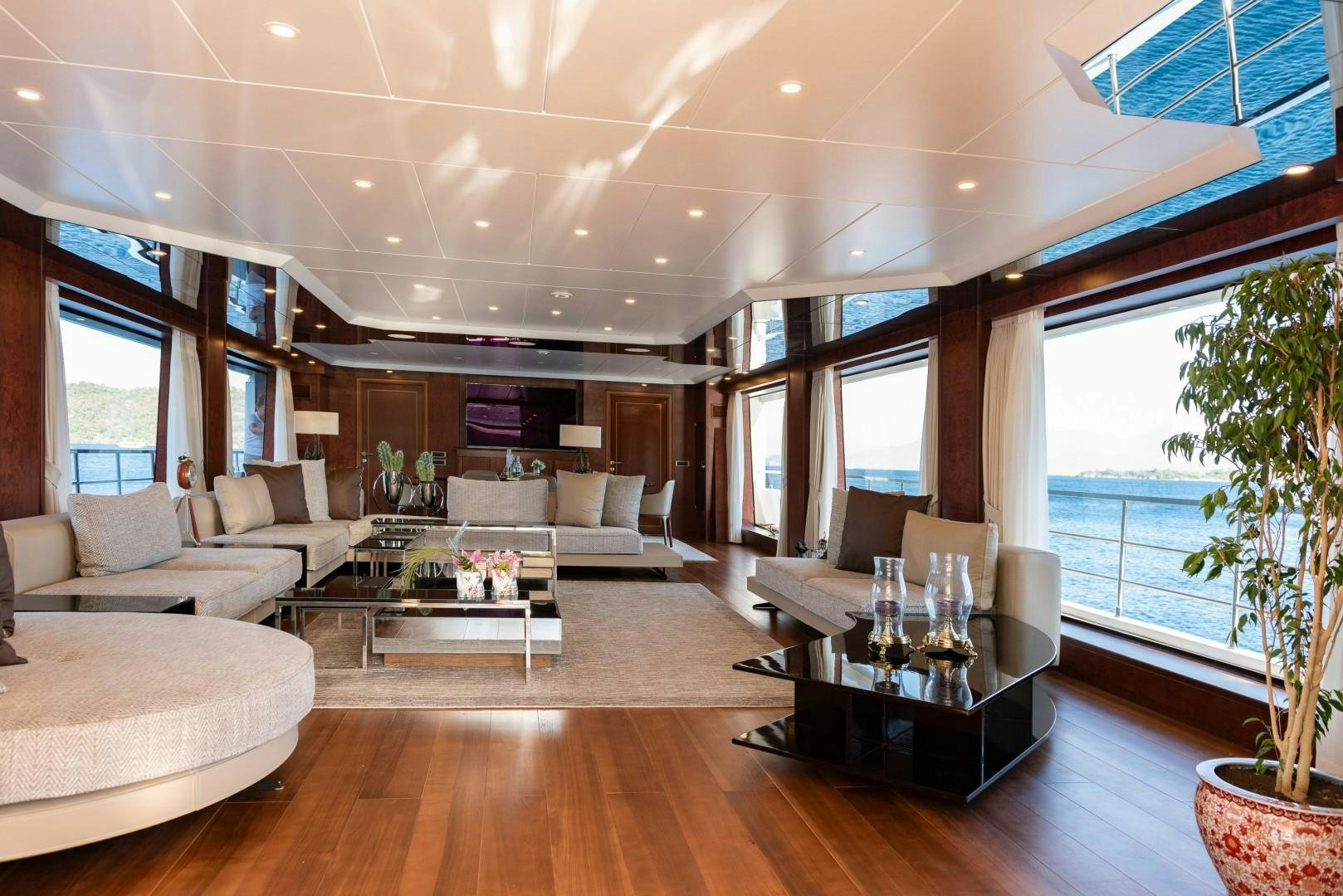 a living room with a large window aboard OCEAN BREEZE Yacht for Sale